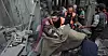 Palestinske redningsarbeidere bærer ut en kvinne som ble såret i et israelsk flyangrep mot flyktningleiren Khan Younis, sør på Gazastripen.