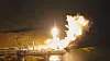 Nattlig oppskyting av Spectrum 2 fra Andøya Spaceport med kraftig flamme og røyk over landskapet.