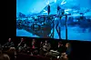 Kinosal med paneldebatt. Lerretet viser et bilde fra filmen Fjord.