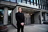 Magne Kristensen står utenfor Næringslivets Hus i mørk dress.